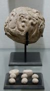 Globular envelope with a cluster of accounting tokens. Clay, Uruk period. From the Tell of the Acropolis in Susa. Susa II or "Uruk period"