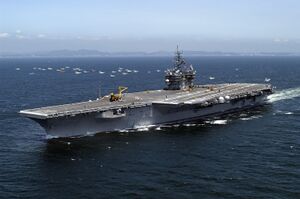 US Navy 050517-N-0120R-127 The conventionally powered aircraft carrier USS Kitty Hawk (CV 63) sails past a small group of Japanese fishing vessels and heads toward Sagami Bay.jpg