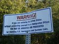 A warning marker at the Canada – United States border at Point Roberts, Washington.