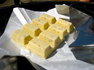 White chocolate bar on foil with embedded with red speckles