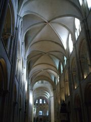 A tall wide church of grey stone elegantly vaulted with fine ribs.