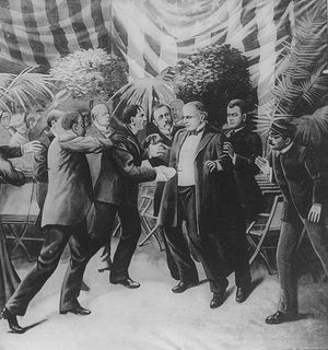 A black-and-white drawing of a crowd of people, one of whom is being watched by all the others, all standing under a draped banner