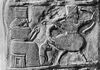 Fragment of a kudurru depicting a girtablullu (right)