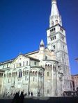 A white stone church with one tall tower.