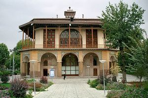 Ornate two-story building, with a person in front for scale