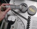 The Geiger counter, invented by Hans Geiger, is a type of particle detector that measures ionizing radiation.