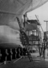 Stern of a cargo ship in the floating drydock of Bremer Vulkan shipyard, on keel blocks overlooking Oertz rudder and propeller