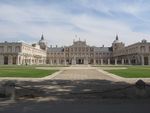 A large palace building with white and orange walls.