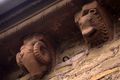 Two Norman corbels, depicting a ram and a lion, supporting the corbel table at Kilpeck