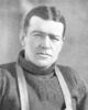Man wearing a thick jumper and over it suspenders.