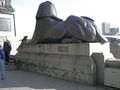 One of two sphinxes at the base of Cleopatra's Needle (لندن). The scars on the pedestal were from fragments of a bomb dropped close to this spot, during a الحرب العالمية الأولى air raid.