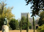 A monument in front of a castle
