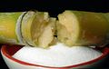 Close-up view of sugar cane & refined sugar