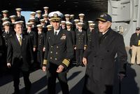 Capt. Kevin E. O'Flaherty, commanding officer of the aircraft carrier يوإس‌إس George H.W. Bush, escorts former President George H. W. Bush, 2009