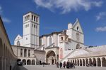 A white church with a white tower next to it.