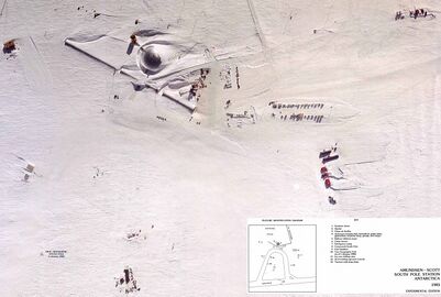 An aerial view of the Amundsen–Scott South Pole Station taken in about 1983. The central dome is shown along with the arches, with various storage buildings, and other auxiliary buildings such as garages and hangars.