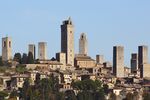 A small town dominated by many tall stone towers